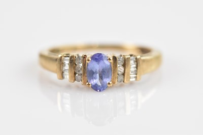 Lot 2571 - A yellow metal dress ring, set with baguette...