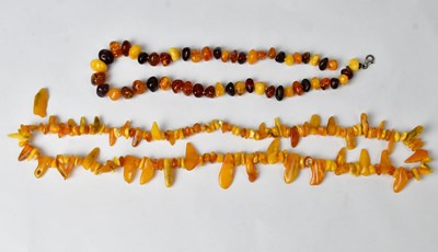 Lot 933 - A butterscotch amber necklace, length 70cm,...