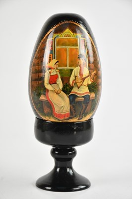 Lot 2289 - A Russian hand painted wooden egg representing...