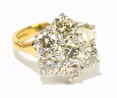 Lot 1004 - An 18ct yellow gold seven stone diamond flower...