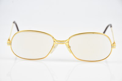 Lot 5 - MUST DE CARTIER; a pair of gold tone...