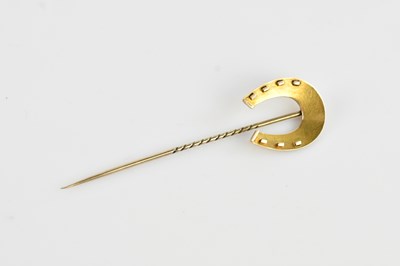 Lot 597 - An Edwardian yellow metal stick pin, modelled...