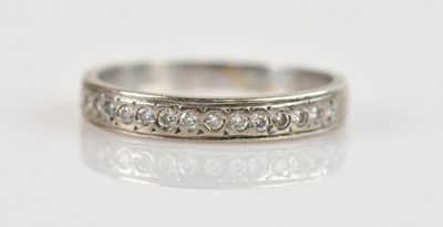 Lot 2440 - A white metal diamond set half eternity ring,...