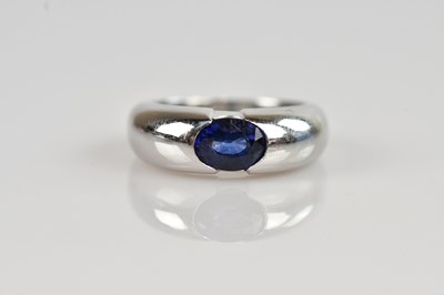 Lot 2349 - A white metal sapphire set band, the oval cut...