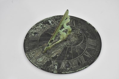 Lot 2157 - A base metal sundial, inscribed 'Swift am I',...