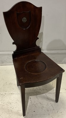 Lot 148 - A 19th century mahogany shield back hall chair.