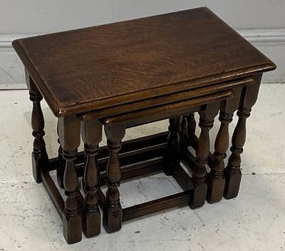 Lot 82 - A reproduction oak nest of three tables,...