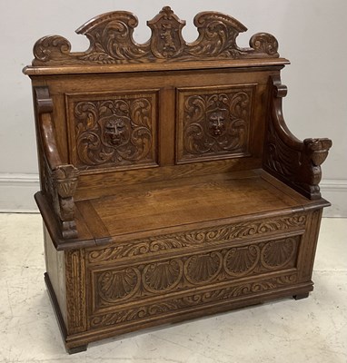 Lot 25 - An early 20th century carved oak settle,...