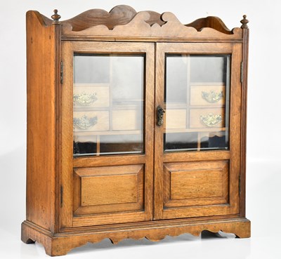 Lot 2193 - An Edwardian oak smoker's cabinet, with two...