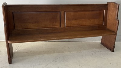 Lot 2041 - A carved oak church pew, length 201cm.