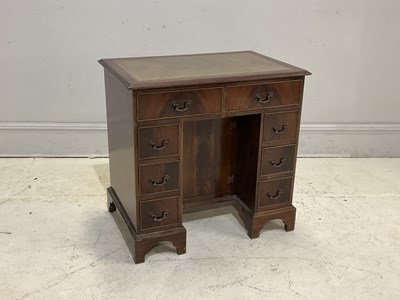 Lot 118 - A reproduction mahogany desk with an...