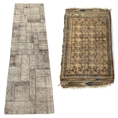 Lot 84 - An antique Belouch beige ground rug, with...
