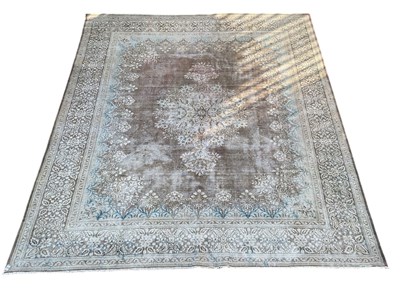 Lot 76 - A large Persian red ground carpet, with...