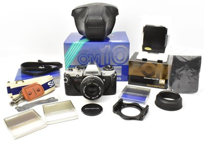 Lot 348 - An Olympus OM10 camera with lens, flash, strap,...
