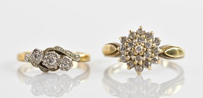 Lot 631 - An 18ct yellow gold and platinum three stone...