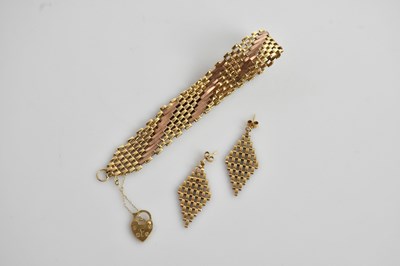 Lot 100 - A 9ct yellow and rose gold gate link bracelet...