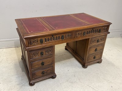 Lot 44 - A reproduction carved oak pedestal desk with...