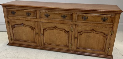 Lot 45 - A reproduction light oak sideboard with three...