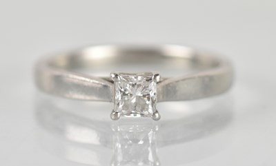 Lot 1239 - A platinum diamond solitaire ring, the central...