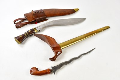 Lot 694 - An Indonesian kris dagger in brass scabbard...