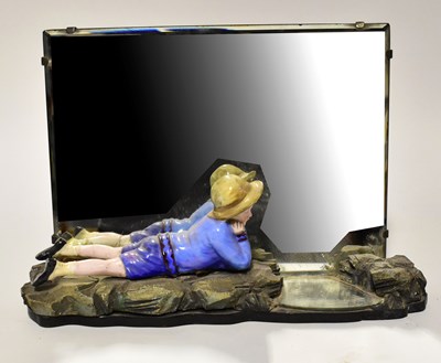 Lot 59 - A figural table mirror, with a young boy...