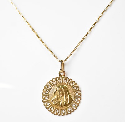 Lot 917 - A circular pendant depicting a female saint,...