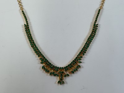 Lot 650A - An Indian yellow metal and emerald set fringe...