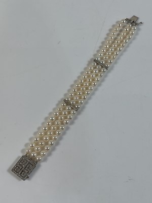 Lot 651A - A three row cultured pearl, 14k white gold and...