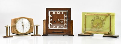 Lot 210 - An Art Deco oak cased mantel clock set with...