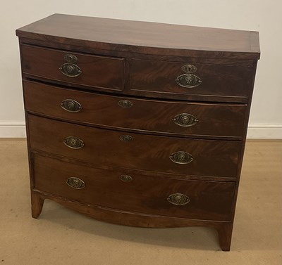 Lot 279 - A mahogany bow fronted chest of three long...