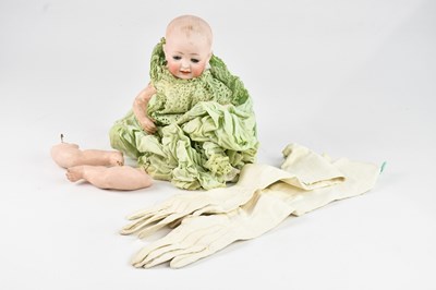 Lot 1414 - A Victorian bisque headed doll in green gown.