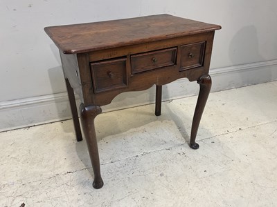 Lot 130 - An early 19th century oak three drawer lowboy,...