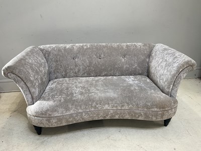 Lot 23 - A modern three seater sofa on ebonised legs.