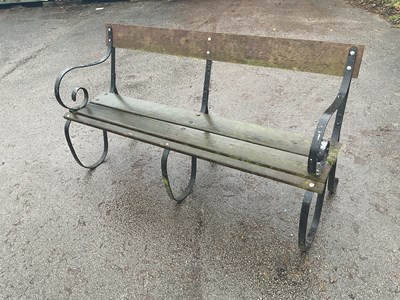 Lot 194 - A black painted garden bench with wooden slats,...