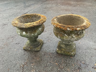 Lot 195 - A pair of reconstituted planter urns, height...