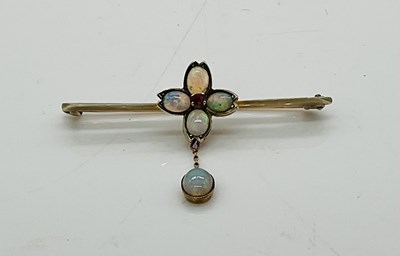 Lot 206 - A 9ct opal and ruby bar brooch with central...