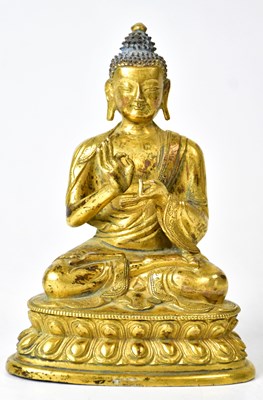 Lot 228 - A Tibetan gilt bronze Buddha statue, posed...