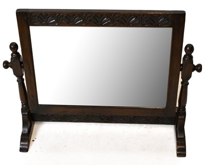 Lot 1538 - A carved oak rectangular dressing table mirror.
