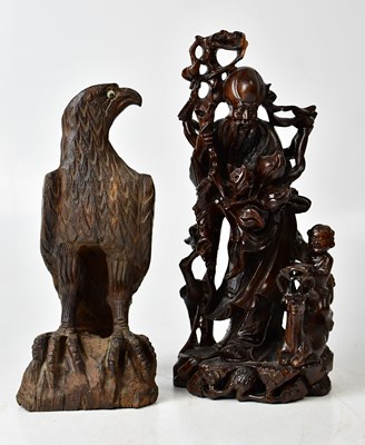 Lot 136 - A Chinese carved hardwood figure of a man,...