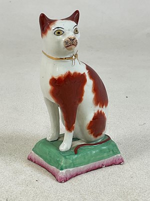 Lot 104 - A 19th century Staffordshire model of a seated...