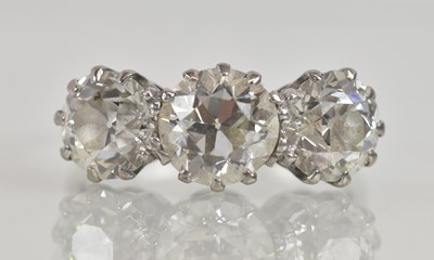 Lot 1213 - An 18ct white gold and platinum three stone...