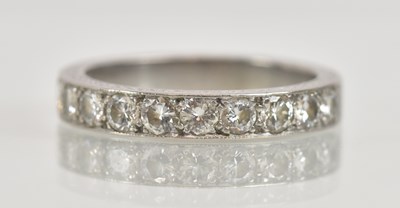 Lot 1228 - An 18ct white gold half eternity ring, inset...