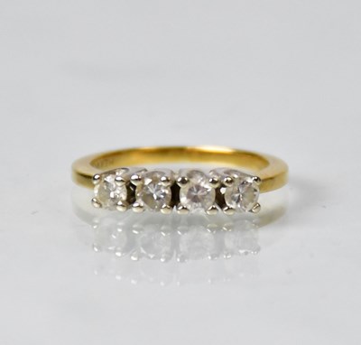 Lot 803 - An 18ct gold ring with four claw set diamonds,...