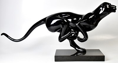 Lot 299 - A large gloss black resin figure of a running...