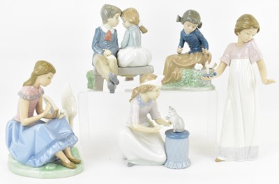 Lot 682 - NAO; four porcelain figures comprising boy and...