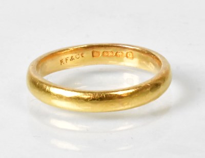 Lot 783 - A 22ct yellow gold wedding band, size N,...