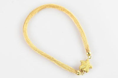 Lot 330 - A textured 9ct yellow gold bracelet, set with...