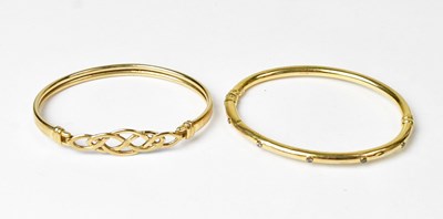 Lot 866 - Two 9ct gold bangles, one with Celtic knot...