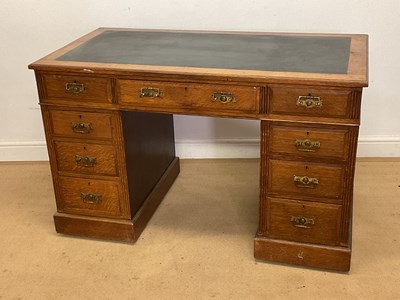 Lot 268 - An Edwardian oak twin pedestal desk, width 123cm.
