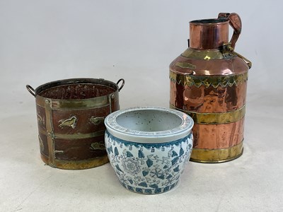 Lot 82 - A copper and brass milk churn with swing loop...